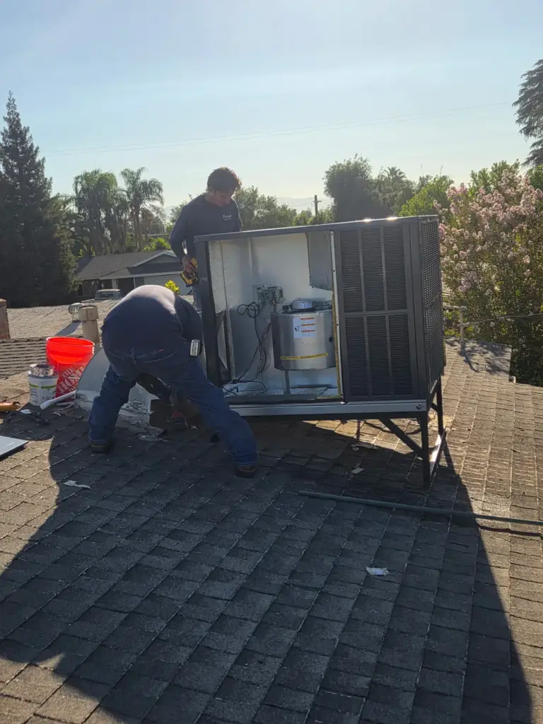 Palmer crew setting a rooftop HVAC unit