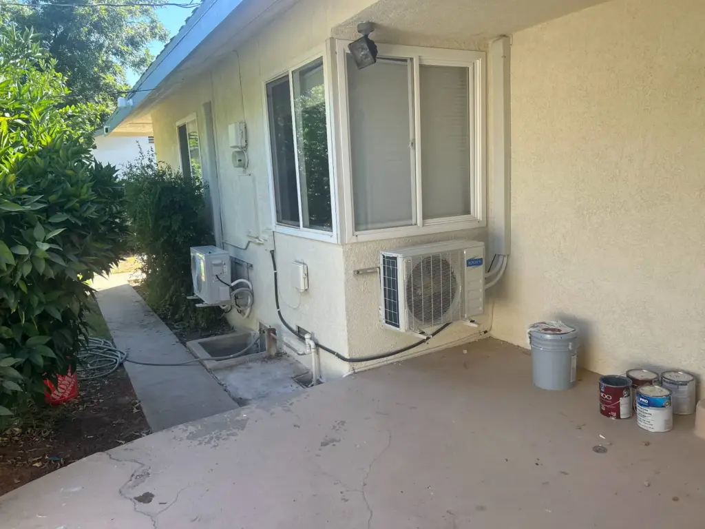 Ductless mini-split outdoor units installed beside a Bakersfield home