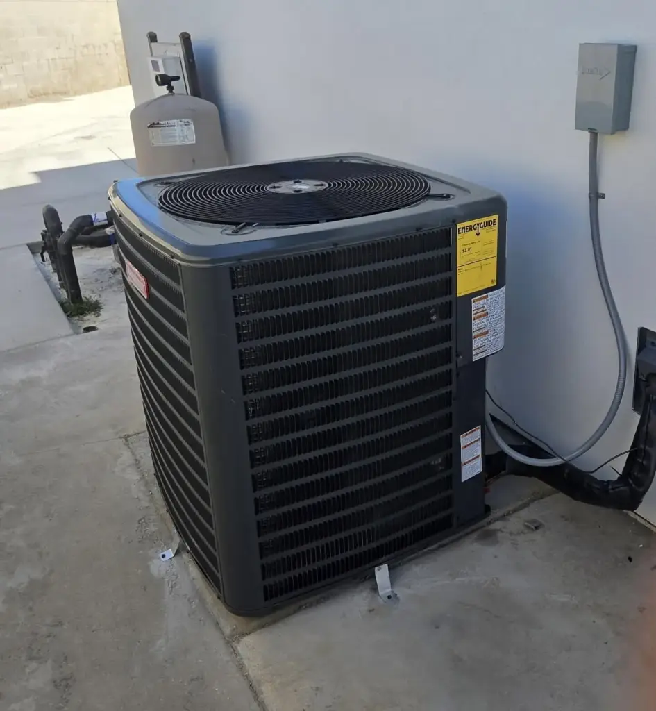 Air conditioning condenser on a pad after a tune-up in Bakersfield