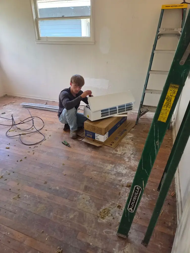 Palmer technician installing ductless heating and cooling equipment inside a Bakersfield home