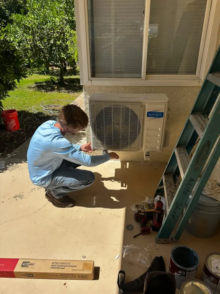 Palmer technician repairing an air conditioning system at a Bakersfield home
