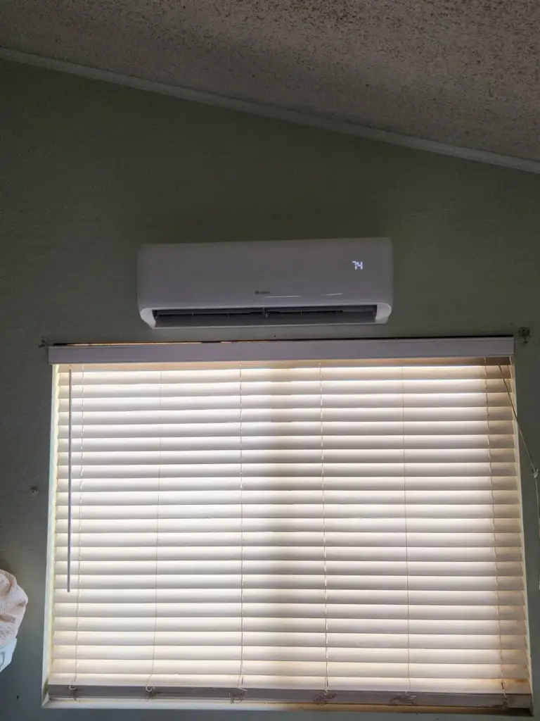 Wall-mounted ductless mini-split above a window